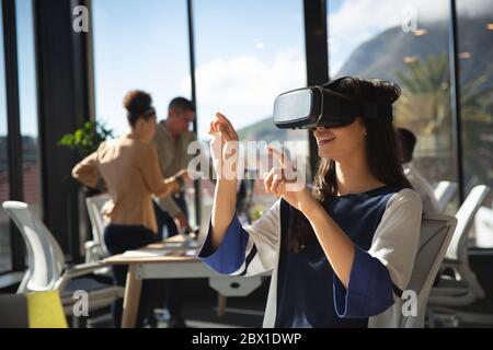 Business people using VR headset Stock Photo