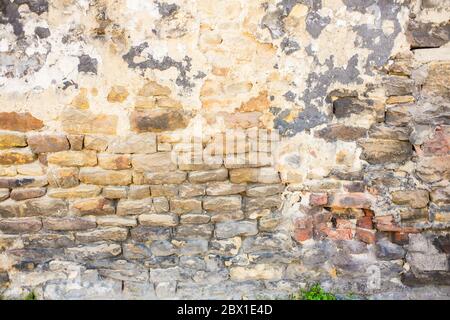 Detail shot of an old brick wall and crumbling cement Stock Photo