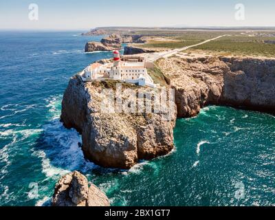 Beautiful lighthouse located on high cliffs of Saint Vincent cape in Sagres, Algarve, Portugal Stock Photo