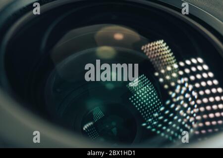 Close up beautiful camera aperture lens with multi colored light glass reflection. Macro view. Stock Photo
