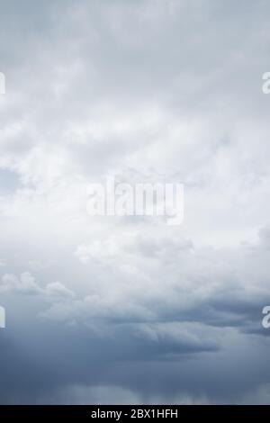Vertical photo of majestic rain clouds over horizon. Cloudy stormy sky with clouds. Stock Photo