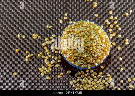 Popcorn kernels. Popcorn is a little different from the usual, as it pops if heated in a popcorn maker or other utensil. It has different requirements Stock Photo