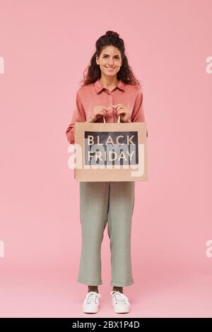 Portrait of beautiful woman doing Black Friday shopping she standing and smiling at camera Stock Photo