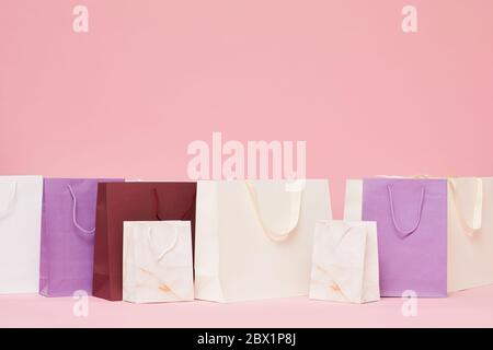Image of different shopping paper bags isolated on pink background Stock Photo