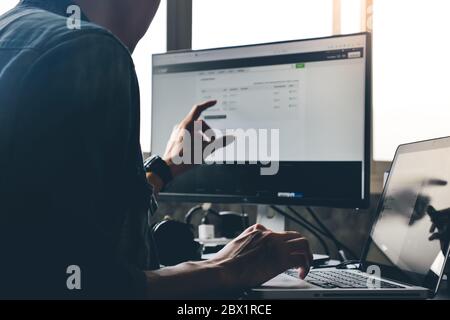 Casual man using computer on the desk. Stock Photo