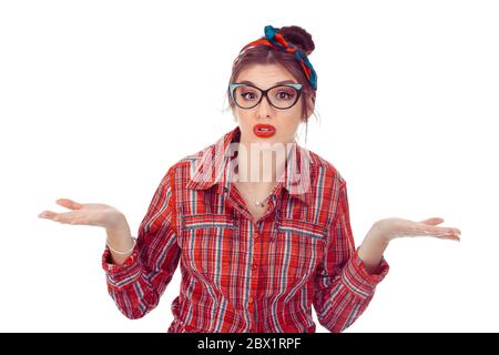 Woman shrugging her shoulders, hands in air. Closeup portrait of a beautiful girl in red checkered shirt and jeans with  bow on head isolated on pure Stock Photo