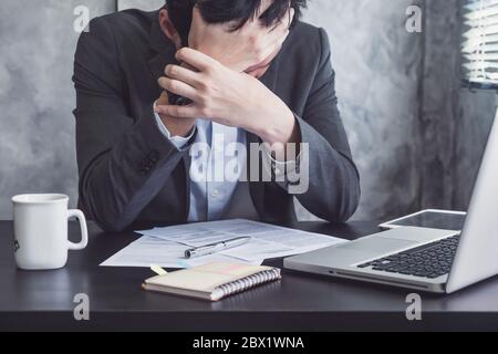 Close up of Depressed businessman sitting in his office room. Stock Photo