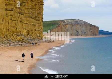 West Bay, Dorset, UK.  4th June 2020.  UK Weather.  The beach is almost deserted at the seaside resort of West Bay in Dorset on an afternoon of cool temperatures and overcast skies.  Picture Credit: Graham Hunt/Alamy Live News Stock Photo