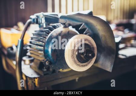 Electrocuting machine - grinding stone on a metal workbench Stock Photo