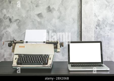 Old Typewriter and Laptop on the desk. Stock Photo