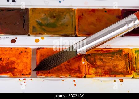 Closeup of watercolor painting process. Paintbrush taking color from inf  palette. Colorful medieval city street on paper board Stock Photo - Alamy