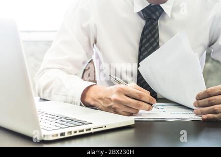 Close up of Businessman checking document on the desk. Stock Photo
