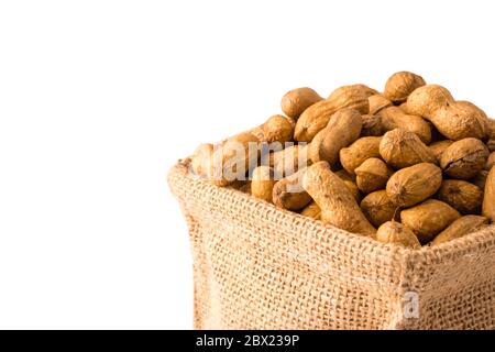 Peanuts in burlap bag on white background. Stock Photo