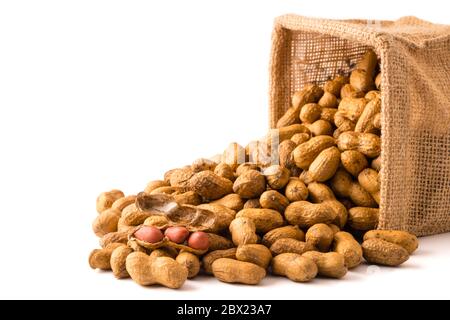 Peanuts in burlap bag on white background. Stock Photo