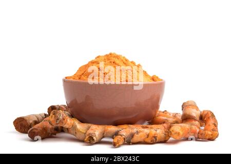 Turmeric roots with turmeric powder on white background. Stock Photo