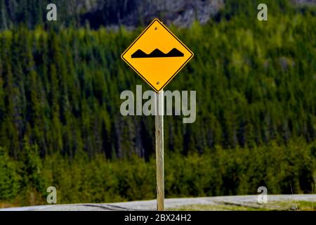 A bump sign on the road warning motorist that there is a bump on the oncoming road Stock Photo