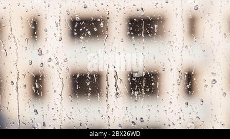 Drops of rain on a window glass on the building panoramic format background Stock Photo