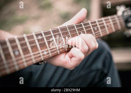 The technique of playing the electric guitar - bending down - heavy hard rock and blues music Stock Photo