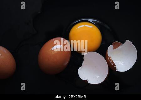 Broken egg on the black floor Stock Photo