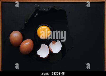 Broken egg on the black floor Stock Photo