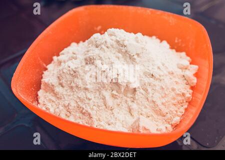 Cooking thin pancakes - kneading dough - flour in a bowl Stock Photo