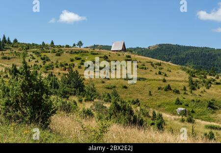 Picturesque summer mountain landscape of Durmitor National Park, Montenegro, Europe, Balkans Dinaric Alps, UNESCO World Heritage. Small wood hut on hi Stock Photo