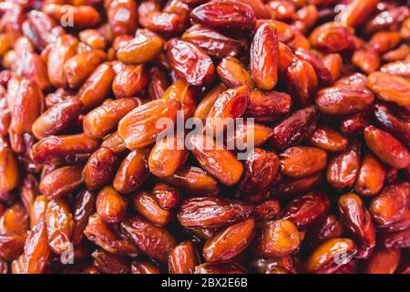 Dates are high in natural sugar - sweet fruits are packed with plenty of nutrients - excellent snack closeup of many dried dates - selected top-qualit Stock Photo