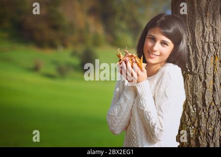 Beautiful girl with yellow leaves in hands . Autumn seasonal portrait Stock Photo