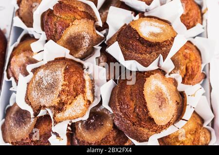 A lot of cupcakes in paper packaging close-up in a confectionery and bakery shop - selected top-quality natural products - selective focus Stock Photo