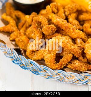 Crispy Breaded Clam Strips Snack Size. Deep Fried Breaded Clams Fingers and French Fried Potatoes with Tartar Dipping Sauce Stock Photo