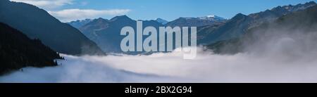 Sunny idyllic autumn alpine scene. Peaceful misty morning Alps mountain panoramic view from hiking path from Dorfgastein to Paarseen lakes, Austria. Stock Photo