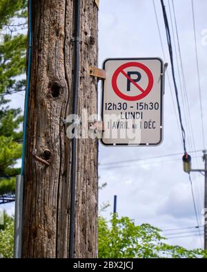 Montreal street no parking sign during specific time for street cleaning purpose in summer Stock Photo