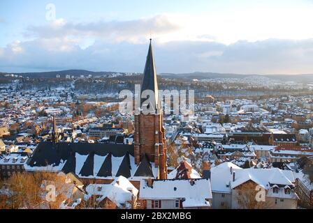 Marburg, Germany, University church and view over the town in winter with snow covered roofs Stock Photo