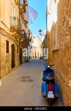 Street in the Old town of Syracuse in Sicily with parked motorbike, Italy - Italian cityscape Stock Photo