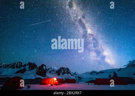 Antarctica, Southern Ocean, Antarctic Peninsula, Graham Land, Wilhelm Archipelago, Hovgaard Island, installation of an ecotourism base camp in the footsteps of the great Norwegian polar explorer Roald Amundsen, at the very place where he bivouacked with his team of exploration in 1911 aboard the Fram, clear night under the Milky Way Stock Photo