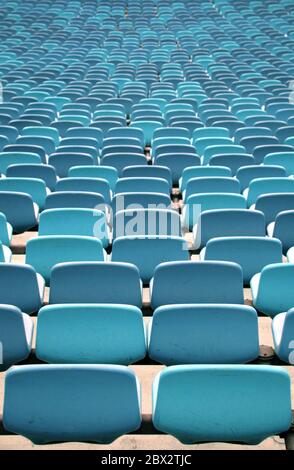 Blue Stadium seating in rows from behind Stock Photo