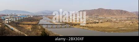China, Jilin province, Yanbian Korean Autonomous Prefecture, Tumen city, elevated panoramic view of the railway border bridge leading to Namyang in North Korea, on the right side Stock Photo