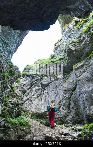France, Drôme (26), Vercors Regional Nature Park, Vassieux-en-Vercors, Plateau de Fond d'Urle, hiker coming out of the Fond d'Urle Glacier Stock Photo