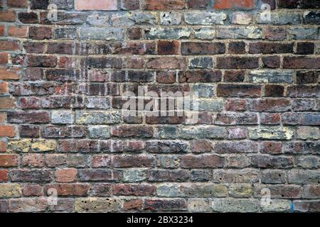 Old weathered brick wall texture - old architectural wall stained and rough in texture Stock Photo