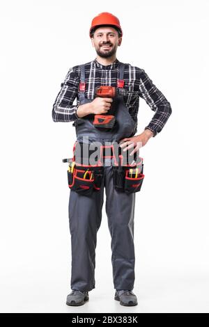 Handsome builder in uniform with tool belt holding drill isolated on white Stock Photo