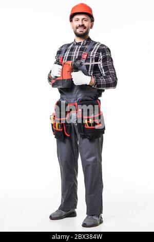 Handsome builder in uniform with tool belt holding drill isolated on white Stock Photo