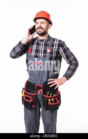Portrait of andyman talking on mobile phone over white background Stock Photo