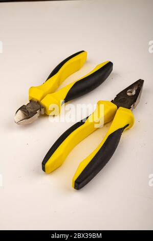 Different pliers on a white background. Close up. Manual locksmith and installation tools for home work Stock Photo