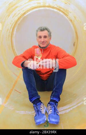 France, Pyrenees Atlantiques, Bearn, Lasseube, Serge Hondet in a fermentation tank which is a viticulturalist producing organic wines from Jurançon and red and rose Bearn Stock Photo