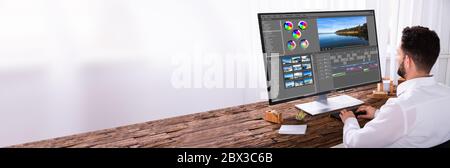 Video Editing On Desktop Computer. Designer Person Stock Photo