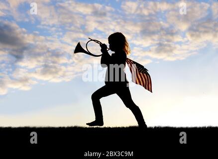 A silhouette of a patriotic little girl child playing and marching outside blowing a french horn and carrying an American Flag. Stock Photo