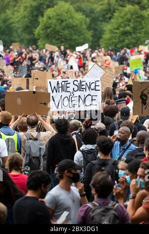 Signs held above a crowd at the Black Lives Matters protest in Hyde Park, London, 3 June 2020 Stock Photo