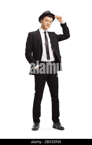 Full length portrait of a guy in a black suit holding his a fedora hat isolated on white background Stock Photo