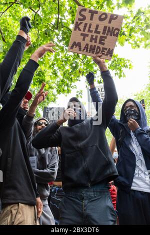 Young men with their arms raised at the Black Lives Matters protest in Hyde Park, London, 3 June 2020 Stock Photo