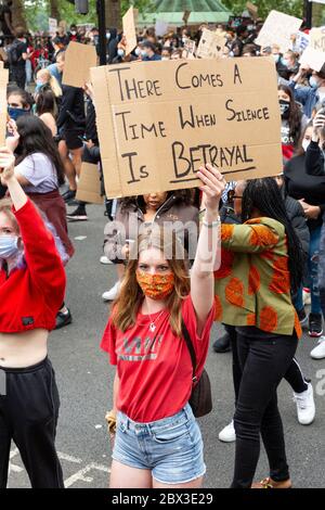 A white girl holding up a sign at the Black Lives Matters protest in London, 3 June 2020 Stock Photo